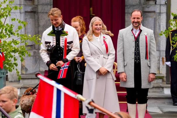 Princess Mette-Marit, Crown Prince Haakon, and Prince Sverre Magnus wave to the children's parade during the May 17 celebration in Skaugum, Asker.