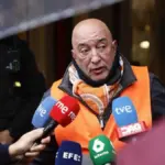 Dozens of people gather in front of the fifth eviction attempt of a retiree by a religious order