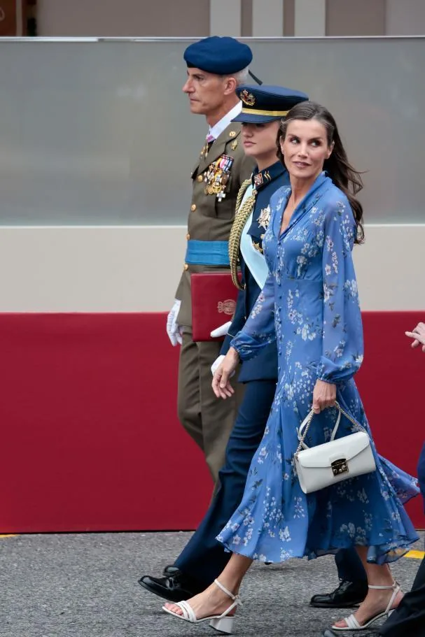 Queen Letizia, wearing a blue dress by designer Juan Vidal, walks alongside Princess Leonor, in Air Force uniform, upon arrival at the parade of the new armored tank of the Army.
