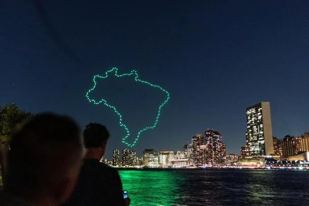 Several people watch drones at an exhibition near the United Nations headquarters to draw attention to the situation of the Amazon rainforest and climate change in New York, September 15, 2023.