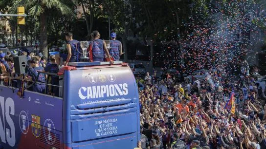 The bus makes its way through the crowd waiting for it