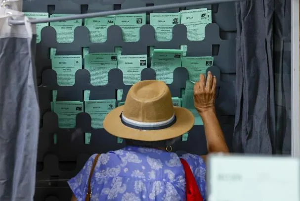 Una mujer ejerce su derecho al voto en un colegio electoral en Sevilla, este domingo. 