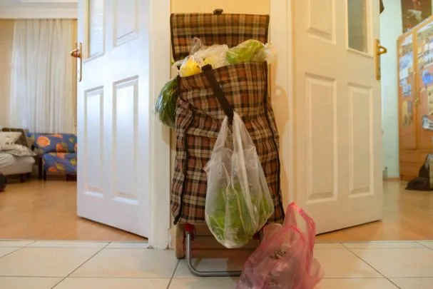 A shopping cart loaded to the brim. The image is a stock photo.