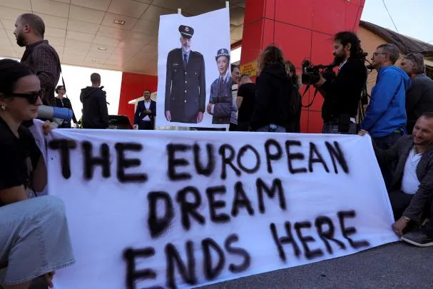 A group of civil rights activists protest against the transfer of immigrants to the Italian detention center in Shëngjin, Albania