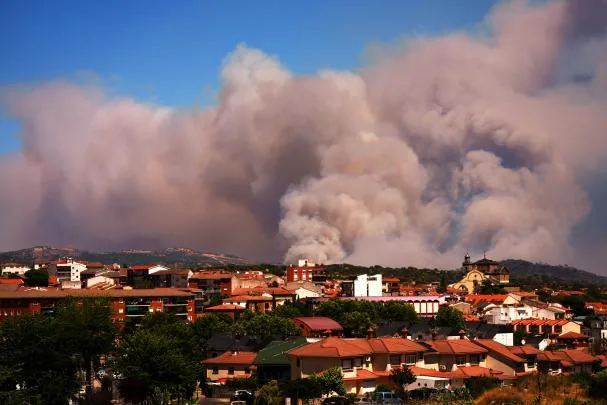 Smoke and flames rise as a forest fire advances near La Adrada, province of Ávila