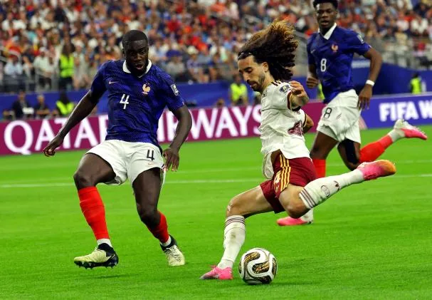 Dayot Upamecano tries to block Marc Cucurella's cross