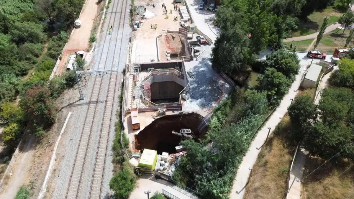 A sinkhole engulfs a crane at the undergrounding works in Montcada i Reixac