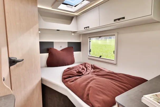 A side window and the skylight illuminate this bedroom 