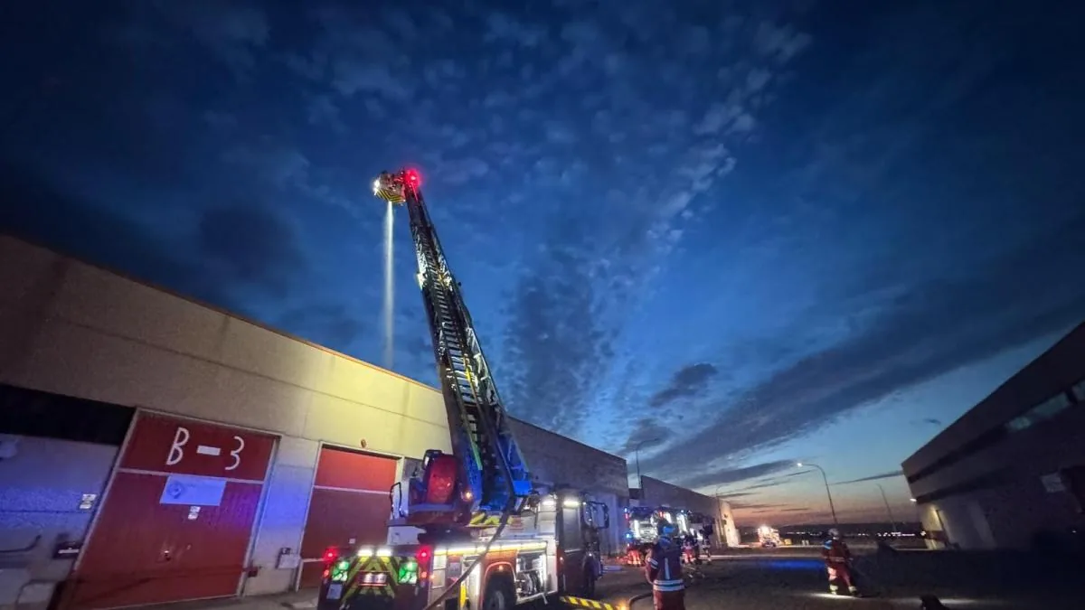 Firefighting crews intervene in the fire at an industrial warehouse in Ajalvir