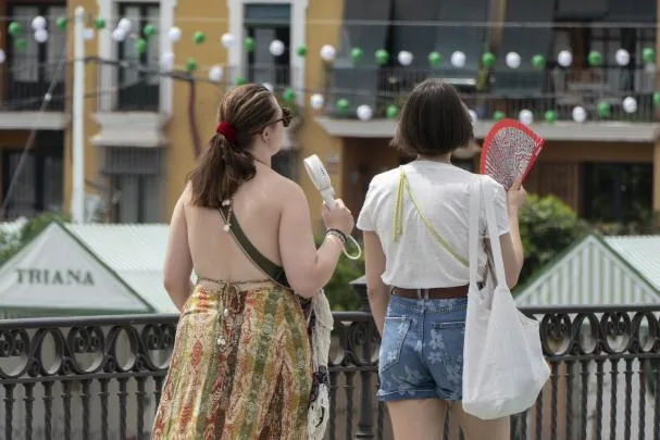 Two people with a fan and a ventilator this Saturday in Seville 