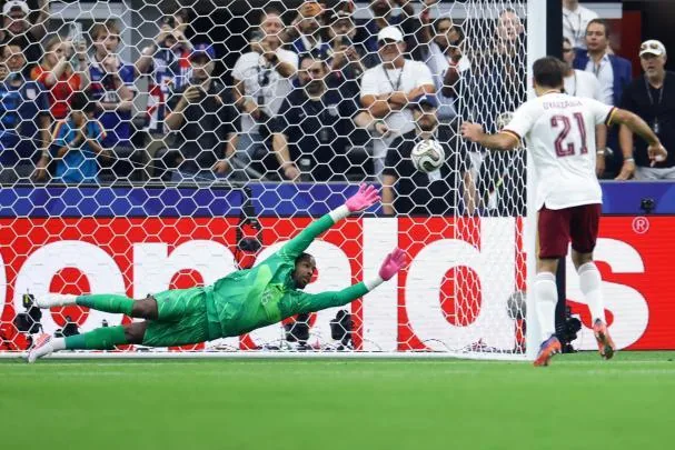 Maignan stretches unsuccessfully in the penalty kick taken by Mikel Oyarzabal to score 0-1
