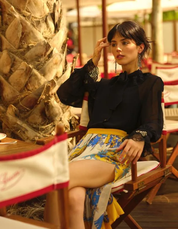 Black chiffon blouse with lace on collar and cuffs Gucci Montecarlo; pleated silk printed skirt Gucci Montecarlo; Gucci bracelet and earrings