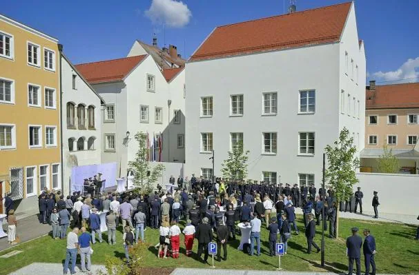 The facade and courtyard of Hitler's birthplace during the inauguration ceremony of the new police station.