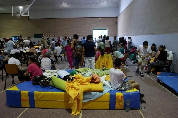 Residents evacuated due to the forest fire near San Martín de Valdeiglesias take refuge in a sports center in Villamanta, west of Madrid