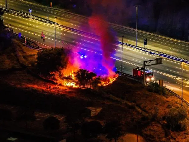 Firefighters working on the fire near the highway in Mataró.