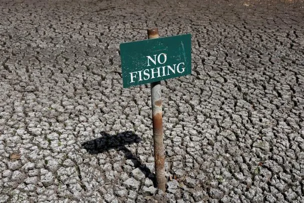 A 'No Fishing' sign at Falmer pond near Brighton (UK), after drought was declared in seven areas of England