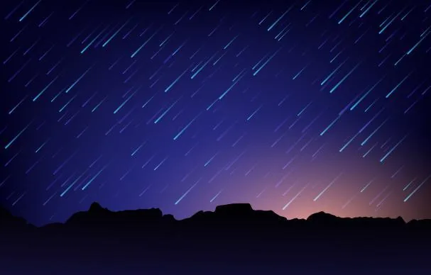 Perseids falling like a meteor shower at mountain dawn