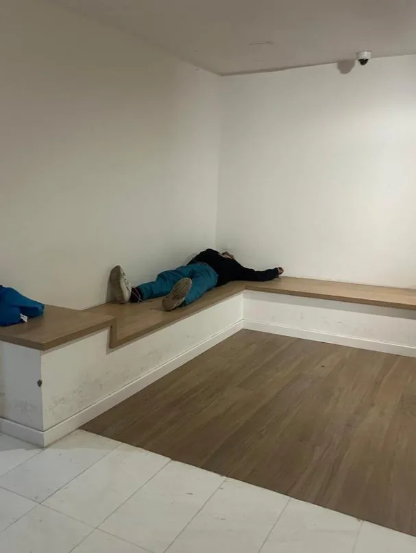 A user of the drug flat on Muntaner Street in Barcelona lying in the building's lobby
