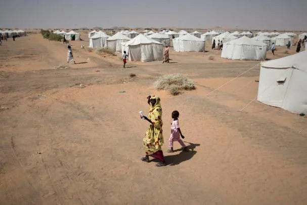 A woman and a child in a displaced persons camp after the El Fasher massacre, when the RSF killed hundreds of civilians