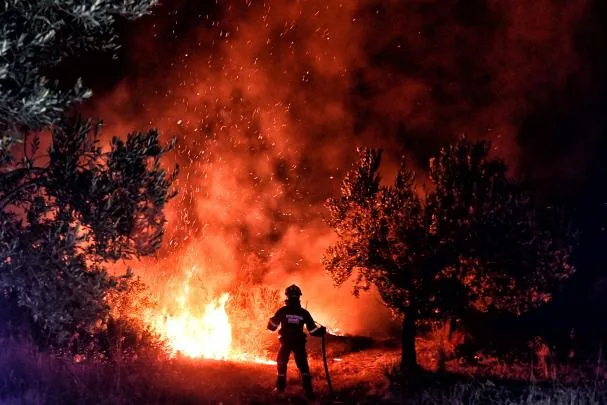 A firefighter working on one of the fires affecting Greece. 