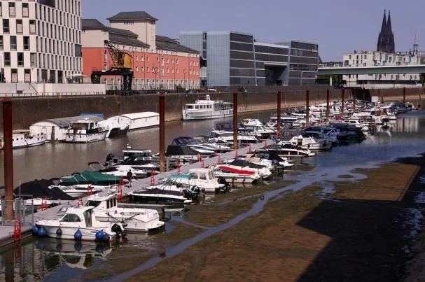 Several vessels remain in the partially dry dock of Rheinauhafen port in Cologne, Germany, due to the low water level of the Rhine River on July 30, 2026.