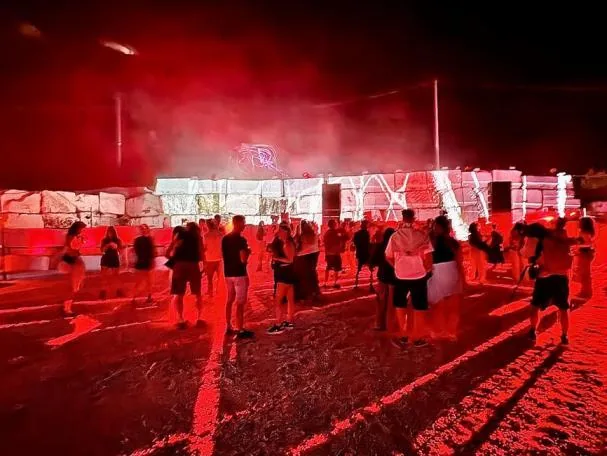 The audience attends the first concert, with the blocks in the background 