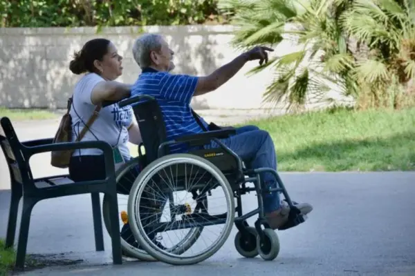 The dependent person may receive various aids and their caregiver may be a neighbor