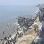 Document | A two-phase assault: young people in wetsuits and families in flip-flops