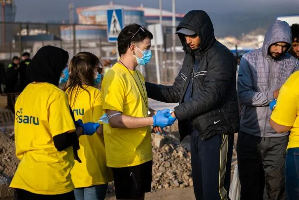 A group of immigrants who have been relocated from the beaches of Benítez and El Trampolín in Ceuta upon their arrival this Friday at the temporary camp set up in the city's port