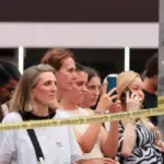 Police shoot a woman wielding two knives after killing one person and injuring another in Times Square