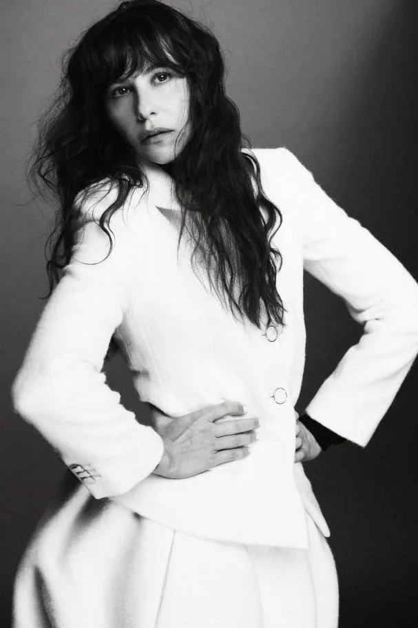 Fitted brushed ivory jacket, black high-neck long-sleeve top, and rounded short ivory wool skirt, all from the Flight Mode collection by Louis Vuitton