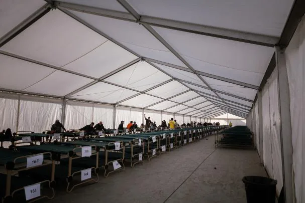 A group of immigrants who have been relocated from the beaches of Benítez and El Trampolín in Ceuta upon their arrival at the temporary camp set up in the city's port